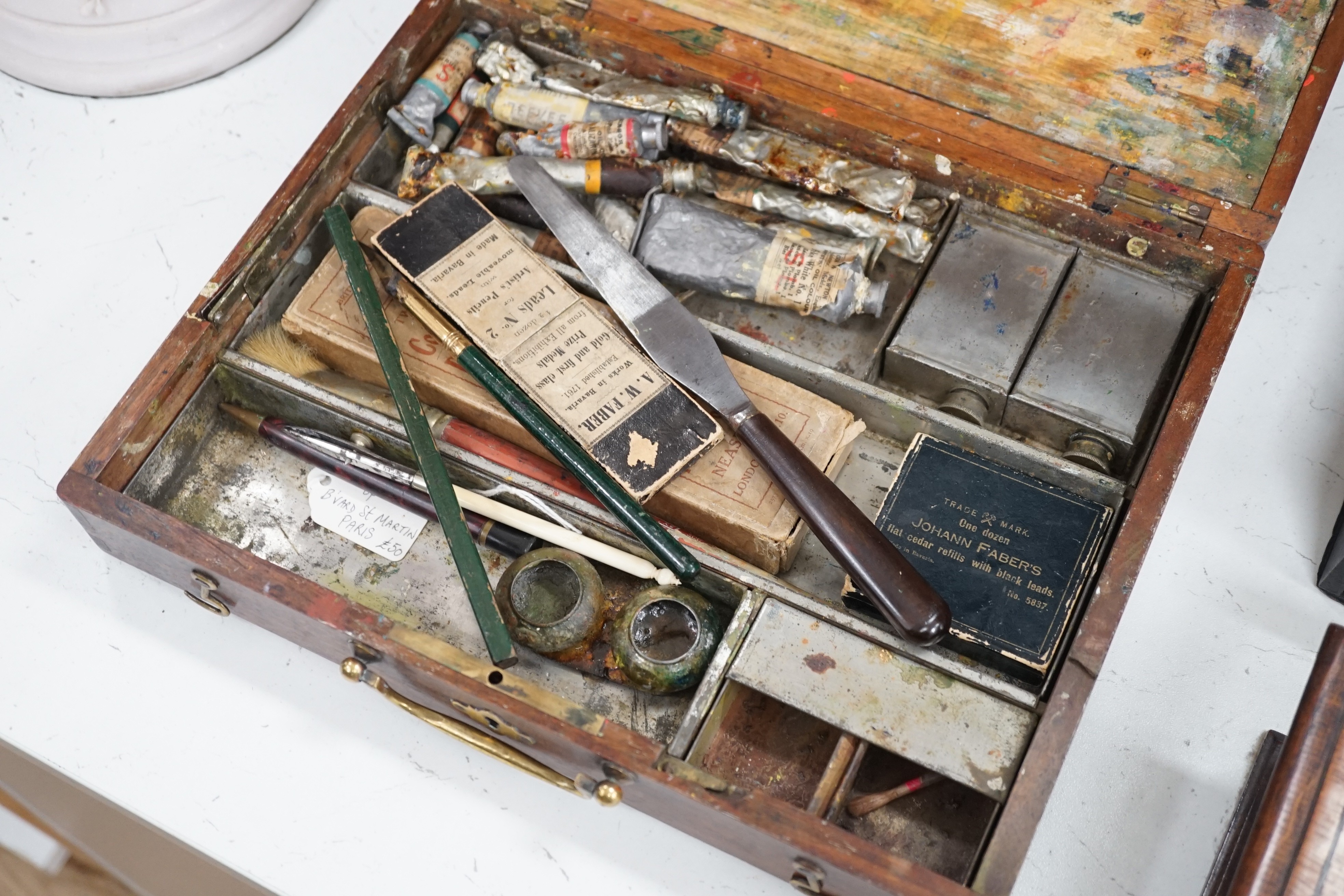 An artist’s paint box with original palette, Windsor and Newton paints, Faber pencils, etc., together with a stationary/pen box and a smokers box, widest 31cm (3)